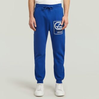 Pantaloni de trening cu grafică și logo multiplu